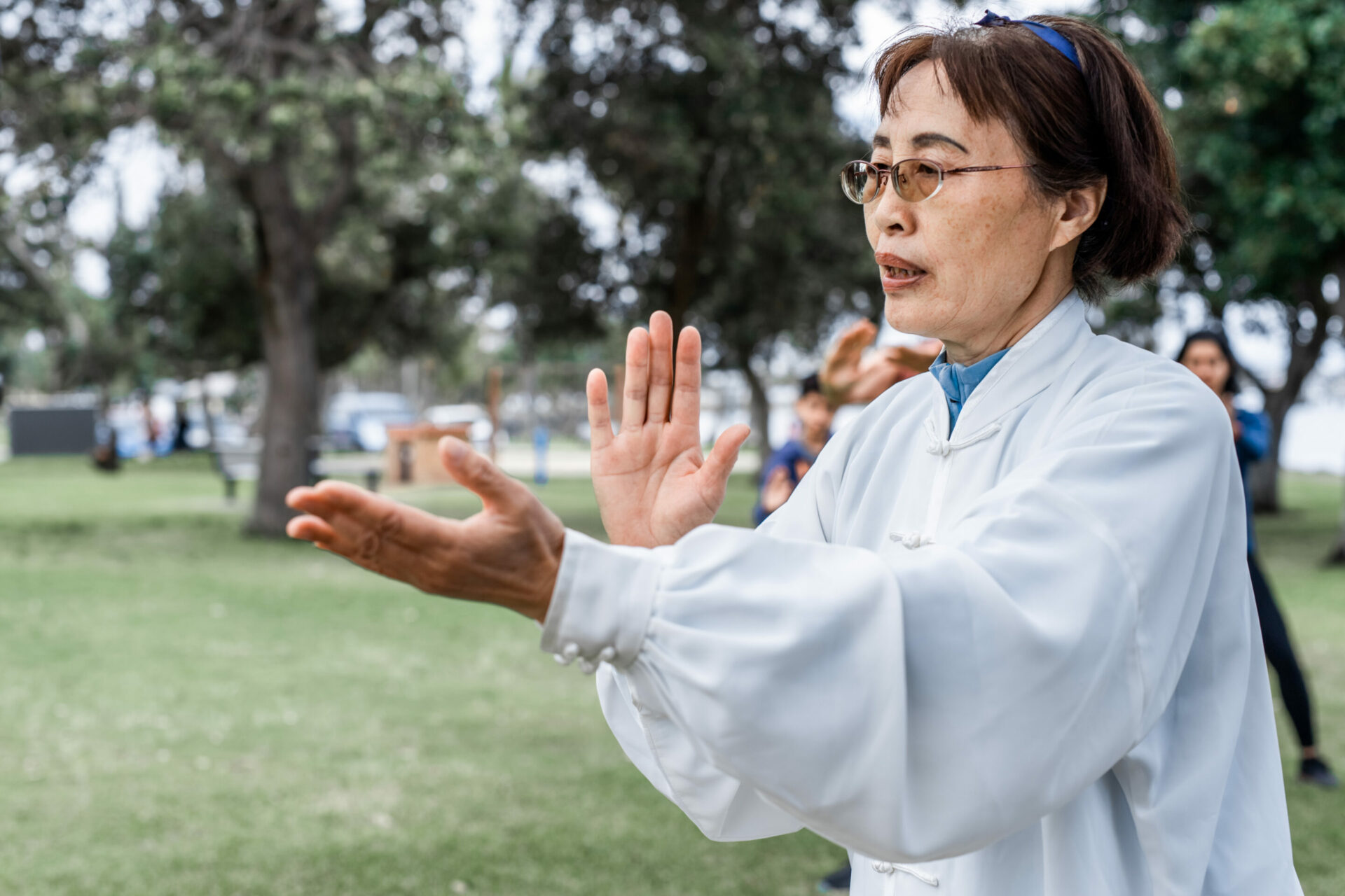 Mature chinese woman do tai chi outdoor brunch-ile-de-re