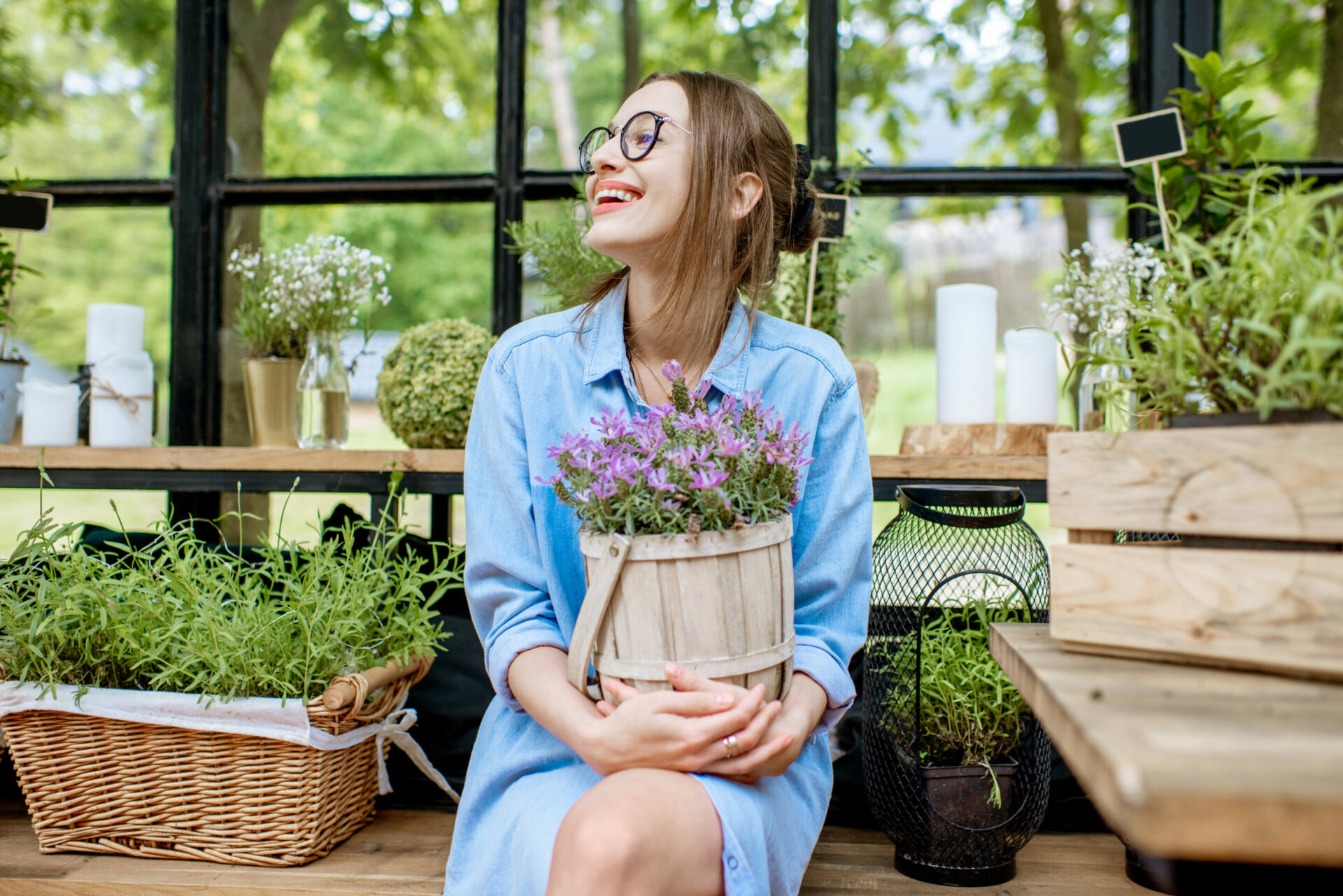 Woman with plants in the greenhouse brunch-ile-de-re